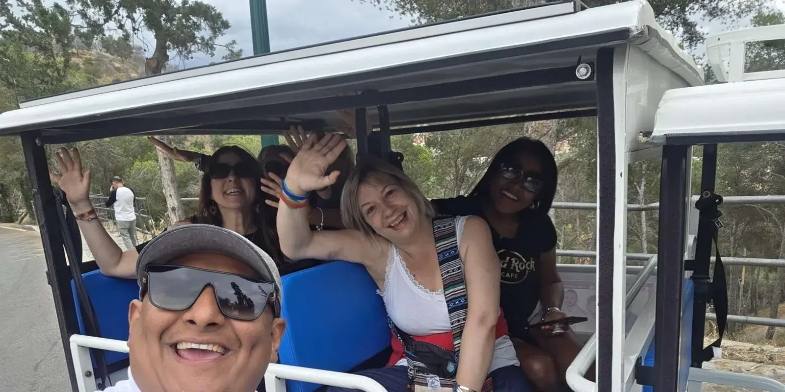 Group posing inside their tuk tuk
