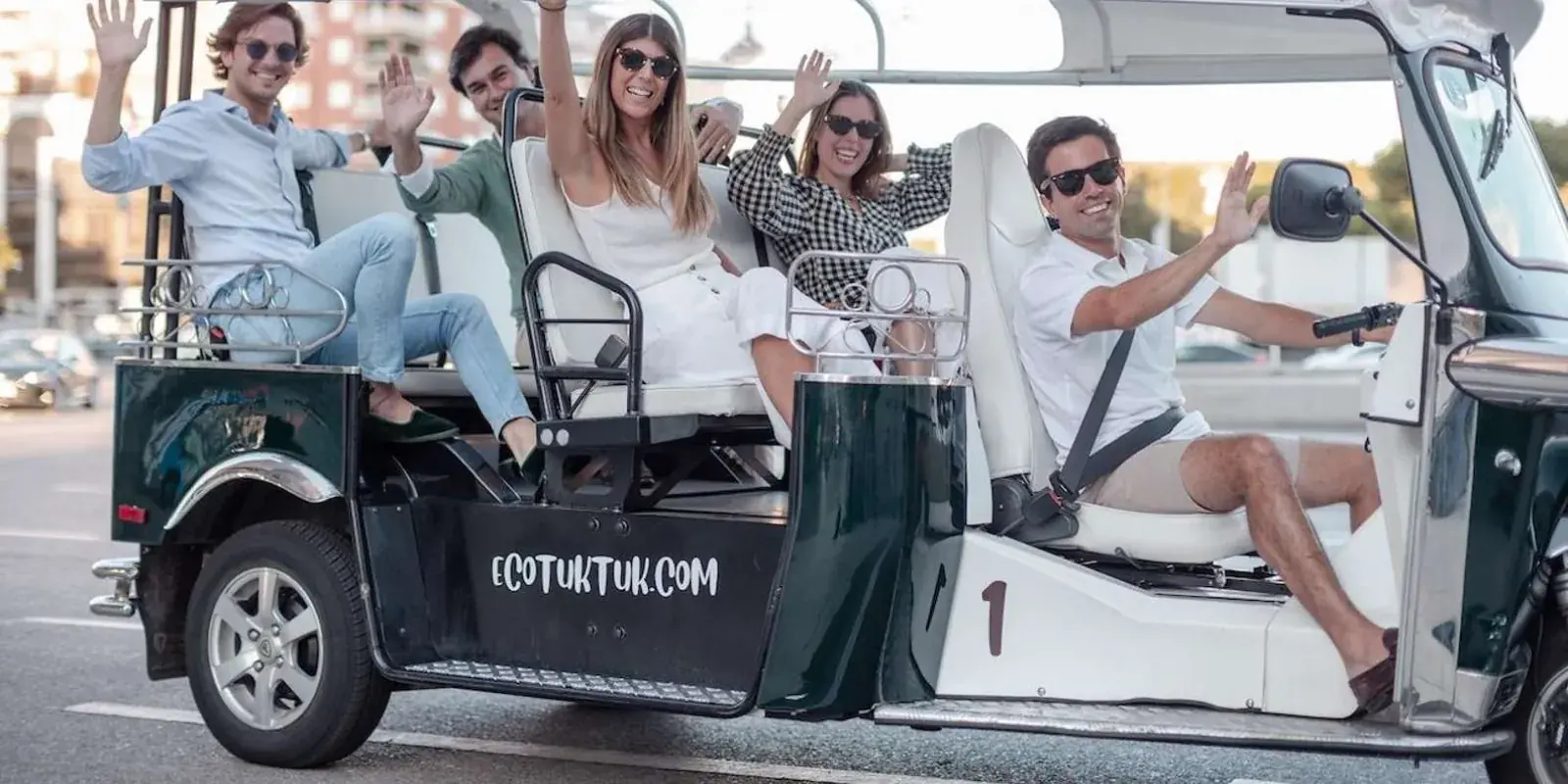 Travellers seated in an Eco Tuk Tuk vehicle