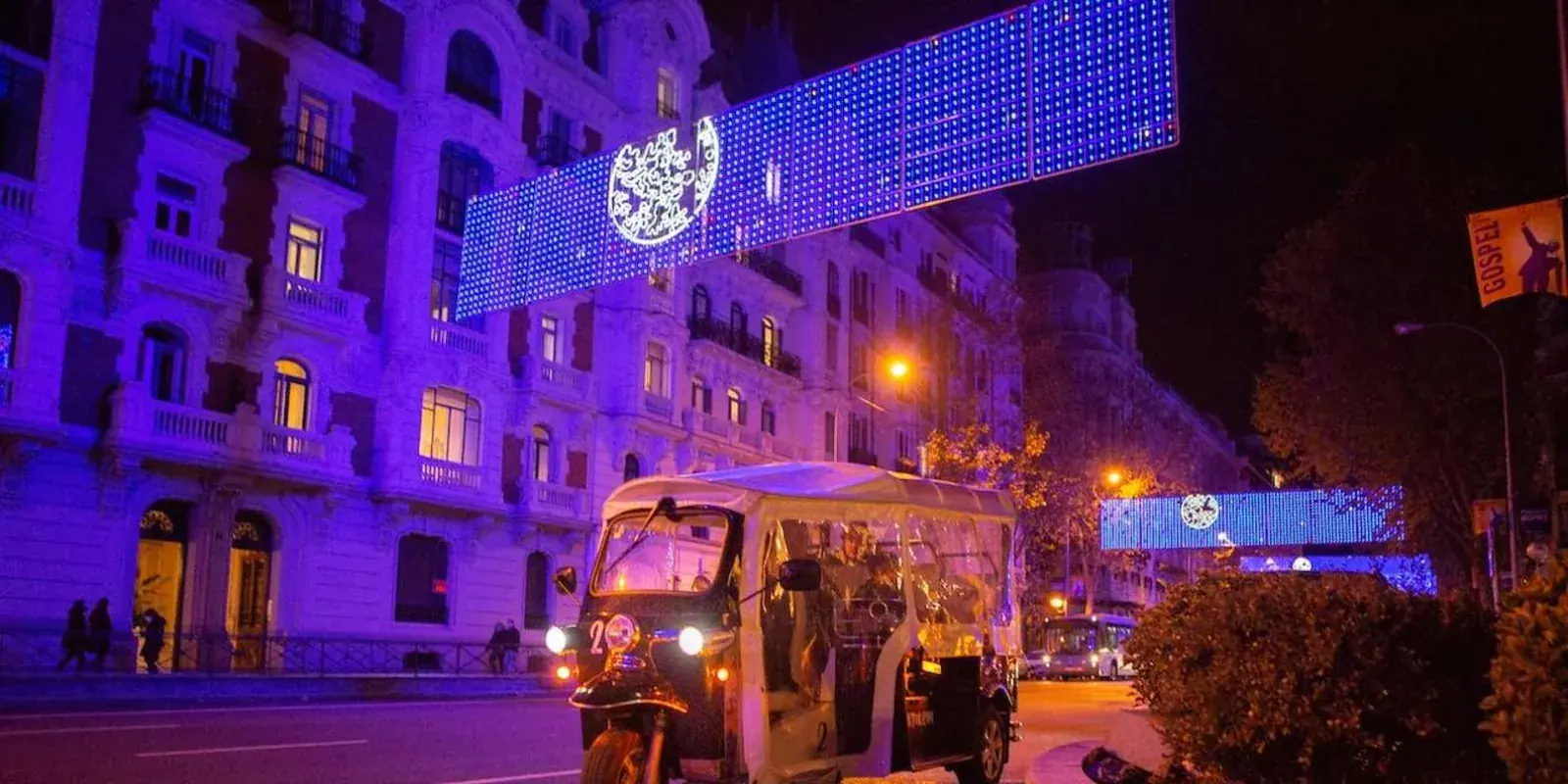 Tuk tuk beside colourful festive lighting