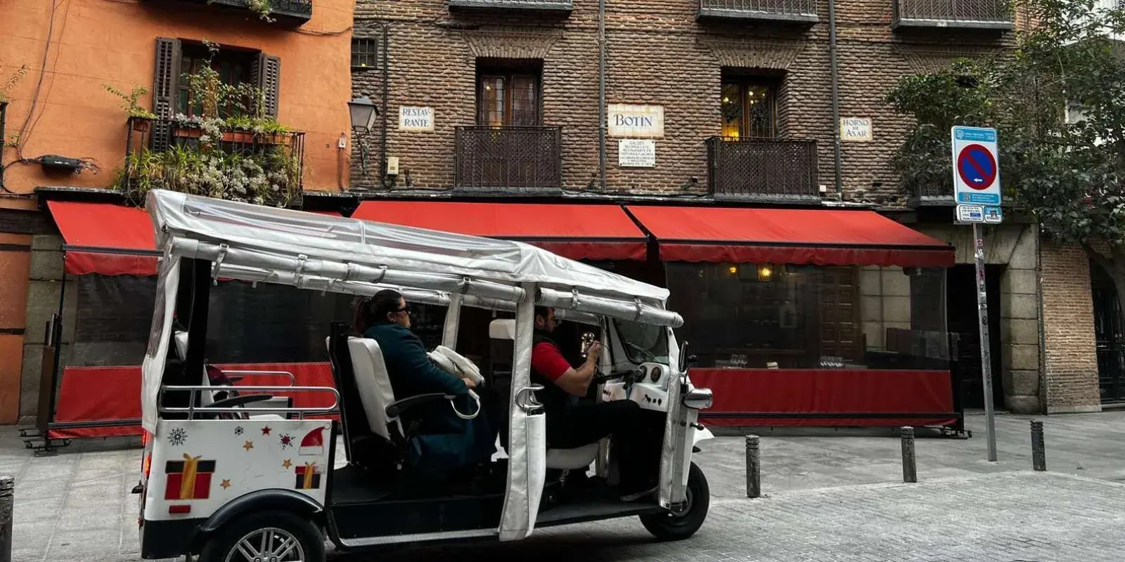 Electric tuk tuk on a central Madrid street